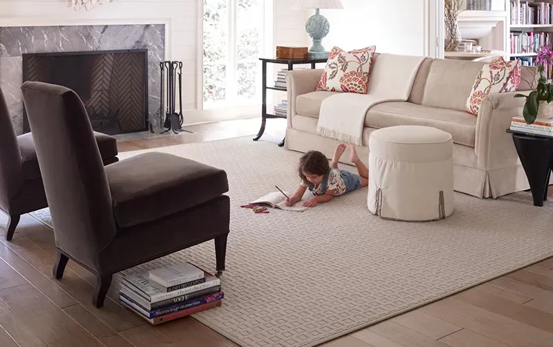 Child drawing on a custom rug in the living room | Chesapeake Family Flooring